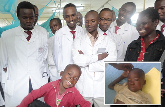 Several smiling doctors surrounding a recovering young boy witha insert photo of when he was a small child and was sick. 